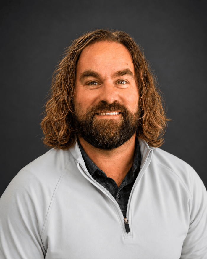 Kris Logsdon headshot, dark background