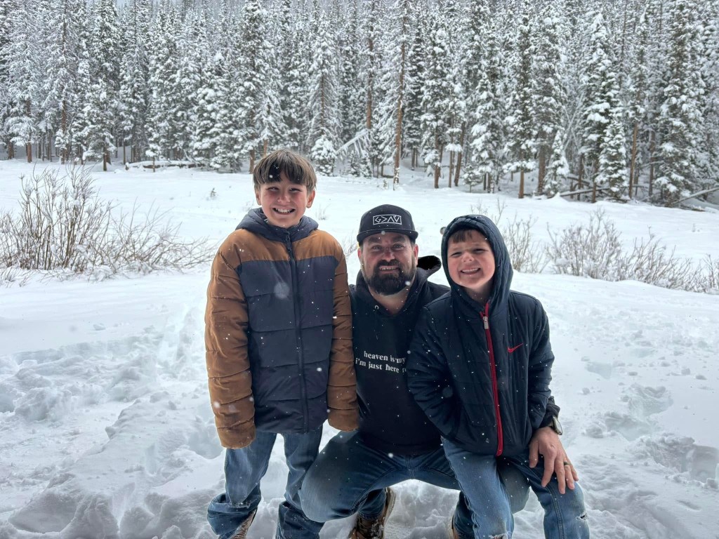 Kris with two of his sons in the snow